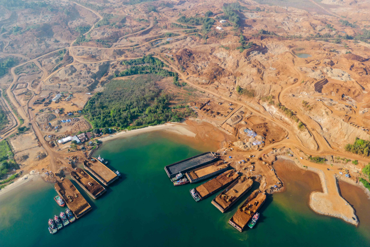 Trucks driving on a jetty unload nickel ore onto barges that will be towed to refining plants further down the coast of Sulawesi island at a mining site in Molawe district on October 27, 2023 in North Konawe, Southeast Sulawesi, Indonesia.