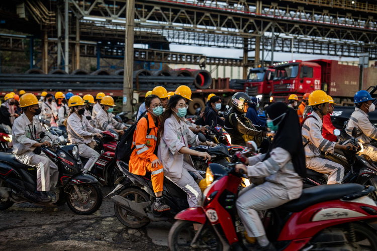 Employees in traffic during the working shift change near Indonesia Morowali Industrial Park (IMIP) on June 10, 2024 in Morowali, Central Sulawesi, Indonesia.
