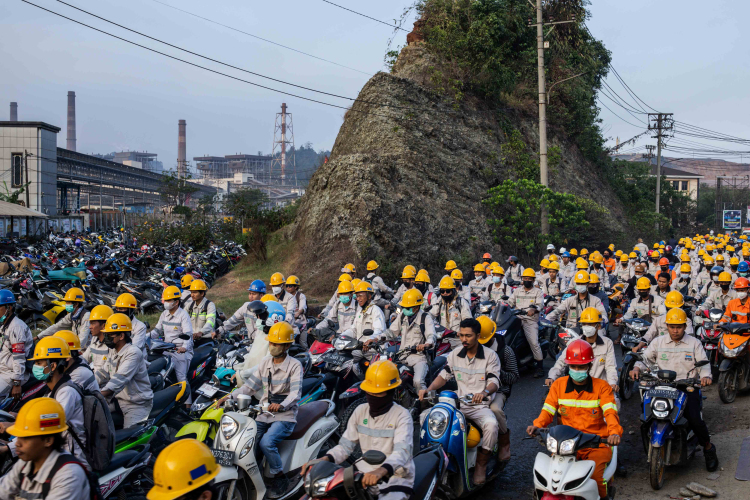 Employees in traffic during the working shift change near Indonesia Morowali Industrial Park (IMIP), that consists of around 66,000 local workers and around 6,000 Chinese workers on October 26, 2023 in Morowali, Central Sulawesi, Indonesia.