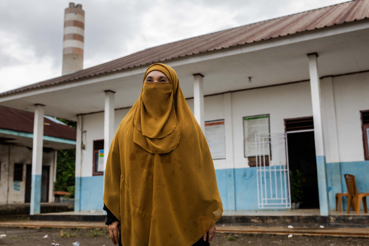 Risma, 33, Headmaster of Madrasah Tsanawiyah Al Jaariyah poses for a photo outside her school in the villages of Labota on June 12, 2024 in Morowali, Central Sulawesi, Indonesia.