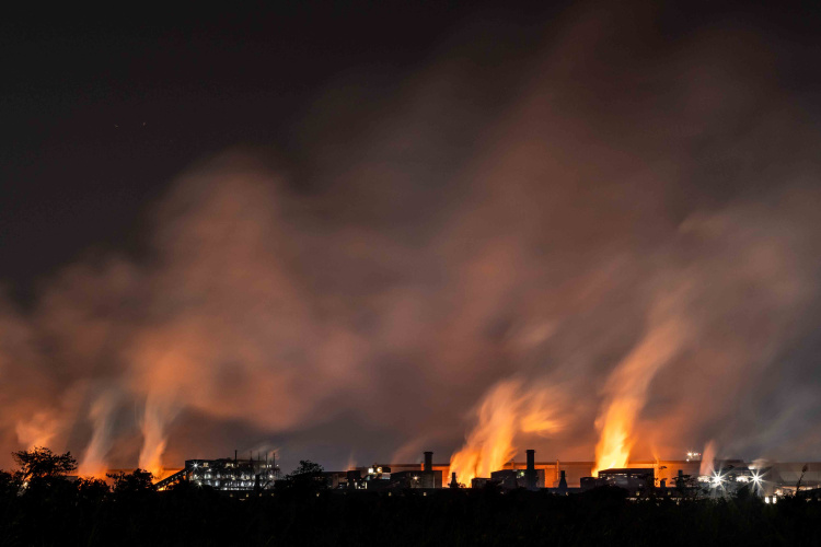 The belching chimneys of PT Obsidian Stainless Steel, a nickel processing complex in Konawe Regency, Central Sulawesi, Indonesia on October 28, 2023. The industrial are powering the move to electric vehicles.